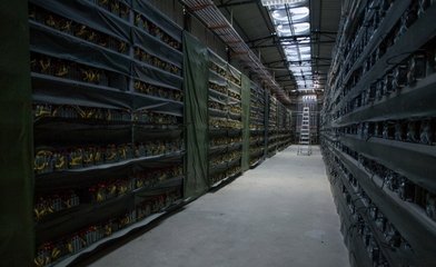 Modern mining farm with rows of hosted cryptocurrency mining machines
