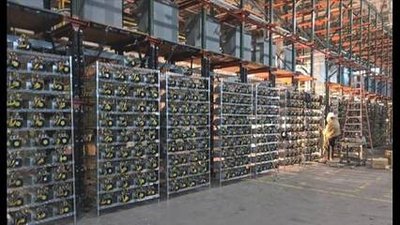 A mining farm with rows of mining rigs, highlighting the scale and infrastructure.